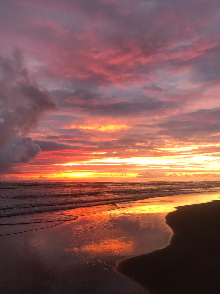 Golden hour beach sunset with dramatic clouds